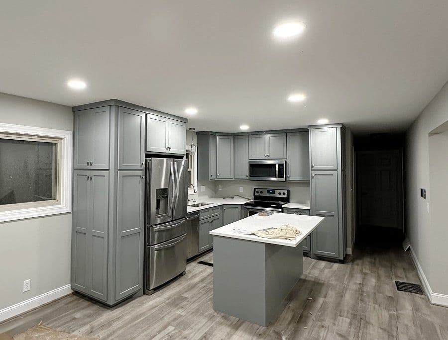 Brick home with green grass and a blue cloudy sky